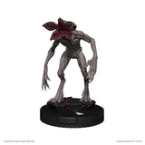 Statue of a creature with a dark flower-like head on a white background