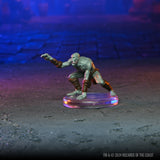 Fantasy figurine on a dark surface with a blue and purple gradient background