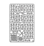 A gray plastic model kit sprue containing multiple unpainted miniature parts, including armor plates, wheels, and medallion insignias, isolated on a white background.