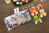 Board game components including cards and a board on a wooden surface