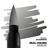 Marker with a gray cap and black body on a white background with gray brush strokes, labeled 'Real Colors Markers'.