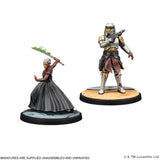 Two miniature figures on stands with a white background
