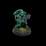 Green futuristic warrior figurine holding a weapon on a black background