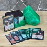 Collection of trading cards on a wooden surface with a green crystal-like object.