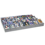 Collection of sports trading cards in a display case on a white background