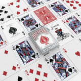 Bicycle Sterling playing cards arranged in a flat-lay pattern, with the silver and red card box centered among several illustrated playing cards.