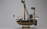 Model of a pirate ship with flags and details on a gray background