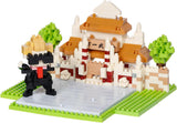 Toy building set with a panda figure and traditional-style house on a white background