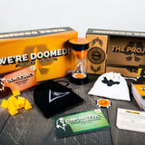Board game components including a box labeled 'We're Doomed!' and various game pieces on a wooden surface.