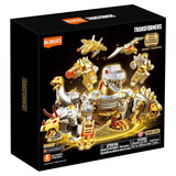 Transformers toy set packaging with gold and silver figures on a black background