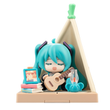 Toy figure with teal hair and a guitar, sitting inside a small wooden teepee.