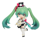 Anime character figurine with green hair and a black and white outfit on a white background