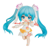 Anime character figurine with blue hair and a colorful outfit on a white background