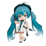 Anime character figurine with blue hair and a white outfit on a white background