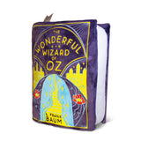 Plush toy shaped like 'The Wonderful Wizard of Oz' book cover on a white background