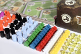 Board game components including colorful plastic tokens and a game box with 'Board & Dice' branding.