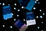 Two glowing cards with text on a dark background with light dots