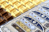 Close-up of game components with a game board featuring symbols on a white background