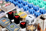 Close-up of a board game with dice, cards, and game pieces.
