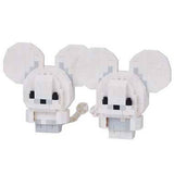 White mouse-shaped figurine with black eyes and ears on a white background