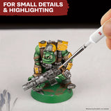 Miniature figure being detailed with a tool on a white background