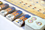 Board game cards with colorful designs on a wooden board