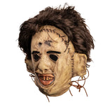 Scary mask with brown hair and stitched details on a white background