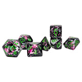 Set of dice with pink and black floral design on a white background