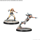 Two miniature figures on stands with a white background
