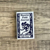 Monster Field Journal cover on a wooden surface