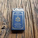 Matchbook titled 'Basic Conjurations vol. 1' by T.S. Romero on a wooden surface