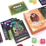Card game components including cards, dice, and a box labeled 'Tanglewood Gold' on a white background.