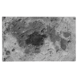 A square abstract art print depicting a textured, cratered gray and black landscape resembling a moon or desert surface, framed by a thick black border.