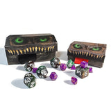 Set of dice with a dragon-themed dice box on a white background