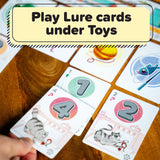 Card game with cards featuring numbers and animals on a wooden surface.