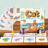Board game 'Cat Between Us' with cards and pieces on a wooden table.