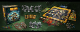 Board game setup with miniatures, game pieces, and box on a green surface
