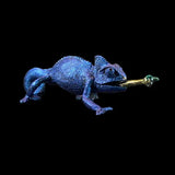Blue chameleon figurine on a black background