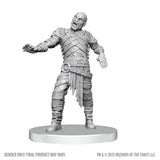 Unpainted miniature figure of a zombie on a white background