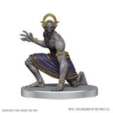 Gray fantasy creature figurine with purple skirt and gold accents on a white background