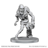 Unpainted monster figurine on a gray base with 'Wizards of the Coast' branding.