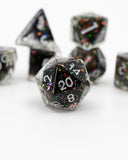 Set of polyhedral dice with black and colorful glitter on a white background