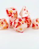 Polished red and white dice with yellow numbers on a white background