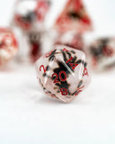 Close-up of a polyhedral dice with red numbers on a white background