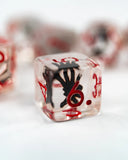 Clear die with black and red design on a white background