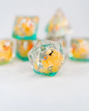 Clear polyhedral dice with colorful penguin design on a white background