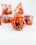 Close-up of orange polyhedral dice with black numbers on a white background