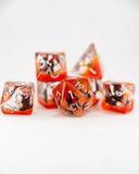 Set of polyhedral dice with red and silver design on a white background