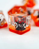 Clear ice cube with black cat design on a white background