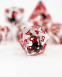 Close-up of red and clear dice with numbers on a white background